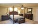 Spacious bedroom featuring a four-poster bed, ceiling fan, and plush carpeting for a comfortable retreat at 6339 Sharp Rock Ct, Las Vegas, NV 89139