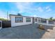 Well-maintained single-story home featuring gravel landscaping and dark trimmed windows at 6425 Evergreen Ave, Las Vegas, NV 89107