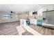 Open-concept kitchen with modern appliances and an adjacent living space, new floors at 6425 Evergreen Ave, Las Vegas, NV 89107