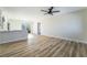 Bright living room boasts new floors, a ceiling fan, and sliding glass door at 6425 Evergreen Ave, Las Vegas, NV 89107