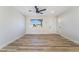 Living room featuring new floors, a ceiling fan, fresh paint and a large window at 6425 Evergreen Ave, Las Vegas, NV 89107