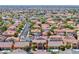 Community aerial view of single Gathering homes with red tile roofs in a planned development at 6617 Fort William St, North Las Vegas, NV 89084