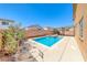 Backyard pool and spa in a desert landscaped yard with a covered patio and lounge area at 6617 Fort William St, North Las Vegas, NV 89084