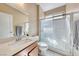 Bathroom features white vanity with solid surface top, glass enclosed shower, white walls, and tile flooring at 6617 Fort William St, North Las Vegas, NV 89084