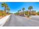 Community entrance with palm trees and beautifully landscaped surroundings at 6617 Fort William St, North Las Vegas, NV 89084
