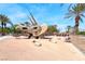 Dinosaur themed park with a stone triceratops sculpture and picnic area at 6617 Fort William St, North Las Vegas, NV 89084