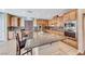 Spacious kitchen features a large center island with granite countertop, wood cabinets, and stainless steel appliances at 6617 Fort William St, North Las Vegas, NV 89084