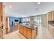 Kitchen island with granite top offers space for dining, and a view of the adjacent living room at 6617 Fort William St, North Las Vegas, NV 89084