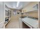 Functional laundry room with modern appliances, shelving for storage, and bright overhead lighting at 6617 Fort William St, North Las Vegas, NV 89084