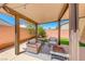 Covered patio with comfortable outdoor seating and patio furniture and a view to the landscaped backyard at 6617 Fort William St, North Las Vegas, NV 89084