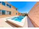 Eye-level shot of a backyard pool and spa combination with a concrete patio and privacy wall on a bright sunny day at 6617 Fort William St, North Las Vegas, NV 89084
