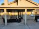 Covered back patio with furniture and grill, perfect for outdoor entertaining and relaxation at 7091 Rhapsody Ln, Las Vegas, NV 89119