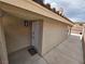 Inviting front entrance with a white door, desert landscaping, and tiled walkway at 7091 Rhapsody Ln, Las Vegas, NV 89119