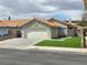 Charming single-story home with a two-car garage and well-maintained artificial lawn at 7091 Rhapsody Ln, Las Vegas, NV 89119