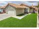 Well-kept single-story house featuring a two-car garage and verdant artificial turf at 7091 Rhapsody Ln, Las Vegas, NV 89119