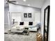 Cozy living area featuring modern decor, tiled floors, a white sofa and recessed lights at 7091 Rhapsody Ln, Las Vegas, NV 89119