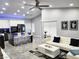 Open-concept living area with a white sofa, tile floors, and an island with seating at 7091 Rhapsody Ln, Las Vegas, NV 89119