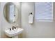 A powder room with a pedestal sink and a large window with blinds at 712 Monroe Hill Pl, Henderson, NV 89011
