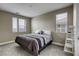 Comfortable bedroom with gray carpet, natural light and a small ladder at 712 Monroe Hill Pl, Henderson, NV 89011
