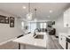 Open floor plan with stairs and a modern kitchen adjacent to the cozy living room at 712 Monroe Hill Pl, Henderson, NV 89011