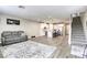 Open-concept living area with modern white kitchen and adjacent staircase at 712 Monroe Hill Pl, Henderson, NV 89011