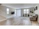 Bright, open living room features wood-look flooring and neutral decor at 712 Monroe Hill Pl, Henderson, NV 89011