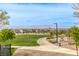 Scenic neighborhood with a lush green park, walking path, and distant mountain views on a bright sunny day at 712 Monroe Hill Pl, Henderson, NV 89011