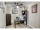 Charming home office featuring a wood desk, artwork, and a ceiling fan at 712 Monroe Hill Pl, Henderson, NV 89011