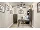 Cozy home office with a dark wood desk and a large ceiling fan at 712 Monroe Hill Pl, Henderson, NV 89011