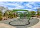 Modern play structure with climbing features, slides, and a soft surface, perfect for outdoor activities at 712 Monroe Hill Pl, Henderson, NV 89011