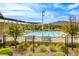 Community pool and lounging area surrounded by landscaping with mountain views at 712 Monroe Hill Pl, Henderson, NV 89011