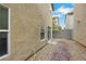 Enclosed backyard area featuring minimal landscaping and a textured exterior wall with sliding glass door access to the home at 7222 Liberty Pride St, Las Vegas, NV 89148