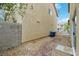 View of gravel backyard with a block wall and two blue recycle bins in the corner at 7222 Liberty Pride St, Las Vegas, NV 89148