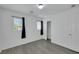 Bedroom with wood-look flooring, two windows, and closet at 7222 Liberty Pride St, Las Vegas, NV 89148