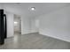 Spacious bedroom featuring light walls, grey flooring, with adjacent doorway to hallway at 7222 Liberty Pride St, Las Vegas, NV 89148