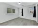 Bedroom with multiple windows, wood-look flooring, and modern ceiling fixture at 7222 Liberty Pride St, Las Vegas, NV 89148