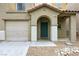 Welcoming front entry with an arched porch, desert landscaping, and attached garage at 7222 Liberty Pride St, Las Vegas, NV 89148