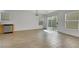 Open living room with a sliding glass door, wood look floors, and light walls at 7222 Liberty Pride St, Las Vegas, NV 89148