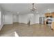 Open-concept living room with wood-look tile flooring, light walls, and stainless steel appliances at 7222 Liberty Pride St, Las Vegas, NV 89148