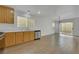 Living area next to kitchen with stainless appliances, good lighting, and wood-look tile floor at 7222 Liberty Pride St, Las Vegas, NV 89148