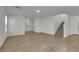 Open living space with light walls, wood look tile flooring, and staircase at 7222 Liberty Pride St, Las Vegas, NV 89148