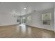 Open living room with wood look tile flooring and sliding glass doors at 7222 Liberty Pride St, Las Vegas, NV 89148