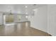 Open-concept living area with wood-look tile floors, chandelier, and staircase at 7222 Liberty Pride St, Las Vegas, NV 89148