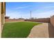 This backyard features a grass lawn area, gravel ground, and a perimeter brick wall at 732 Rosewater Dr, Henderson, NV 89011