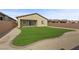 This backyard features a grass lawn area and gravel ground with a brick border lining the grass at 732 Rosewater Dr, Henderson, NV 89011