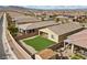 Inviting backyard features a perfectly manicured lawn and neutral colored exterior at 732 Rosewater Dr, Henderson, NV 89011
