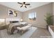 Neutral bedroom featuring a bed, bench, stylish decor, and a window providing natural light at 732 Rosewater Dr, Henderson, NV 89011