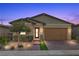 Charming single-story home featuring desert landscaping, a brick driveway, and a two-car garage at 732 Rosewater Dr, Henderson, NV 89011