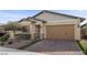 Charming single-story home featuring desert landscaping, a brick driveway, and a two-car garage at 732 Rosewater Dr, Henderson, NV 89011