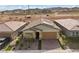 This home features a brick driveway, landscaped front yard, and an attached two-car garage at 732 Rosewater Dr, Henderson, NV 89011